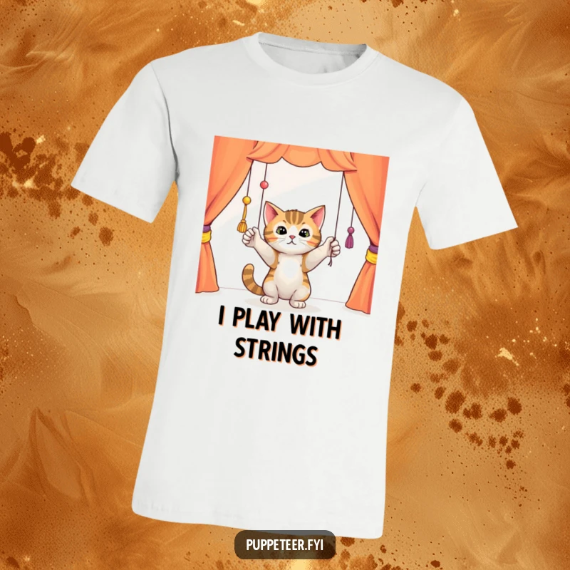 Funny curious cat batting playfully at dangling puppet strings in a colorful theater, graphic tee shirt, capturing a moment of playful mischief.