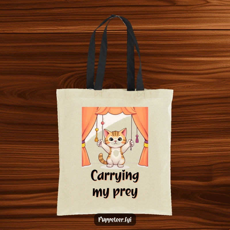 Funny curious cat batting playfully at dangling puppet strings in a colorful theater, durable tote bag, ideal for carrying essentials with feline charm.